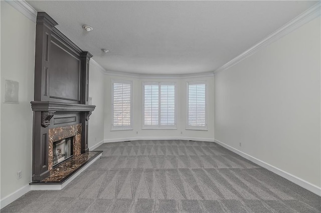 unfurnished living room with ornamental molding, a high end fireplace, and light carpet