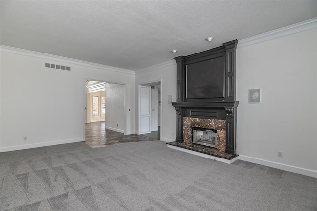 unfurnished living room with dark carpet, crown molding, and a fireplace