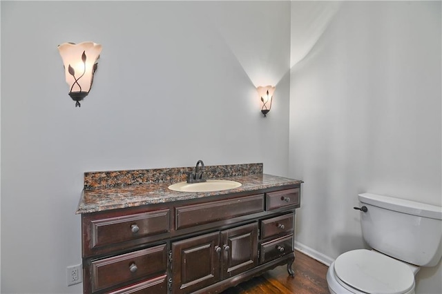 bathroom with vanity, wood-type flooring, and toilet