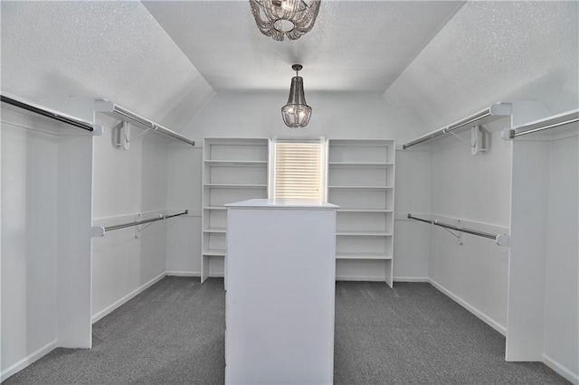 walk in closet featuring dark carpet and vaulted ceiling