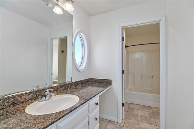 full bathroom featuring washtub / shower combination, vanity, toilet, and tile patterned flooring