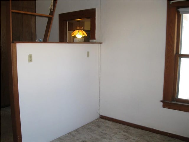 carpeted empty room featuring a wealth of natural light