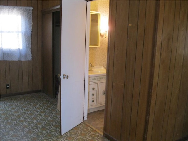 bathroom with wood walls and vanity