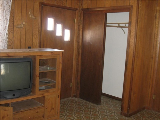 interior space with wood walls and baseboards