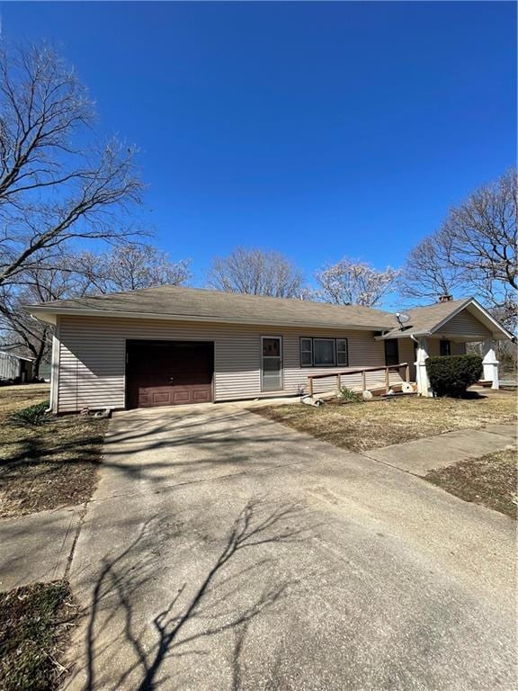 ranch-style home with a garage and driveway