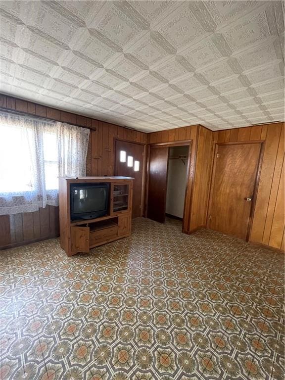 kitchen featuring brown cabinets and wood walls