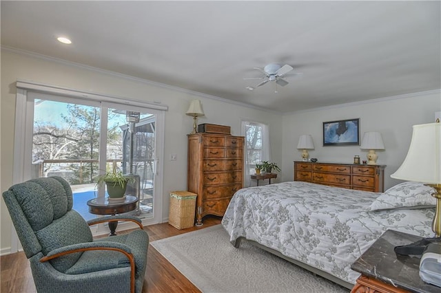 bedroom featuring hardwood / wood-style flooring, access to exterior, ceiling fan, and multiple windows