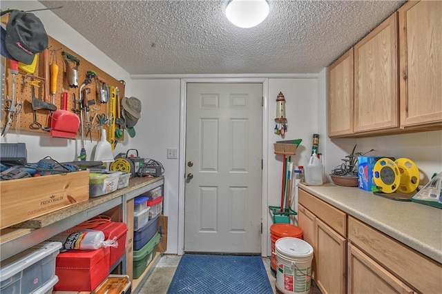 clothes washing area featuring a textured ceiling