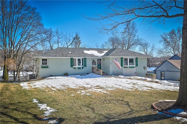 view of front of property with a yard and central air condition unit