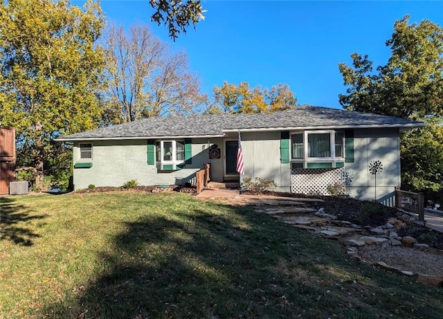 ranch-style home with brick siding, cooling unit, entry steps, and a front yard