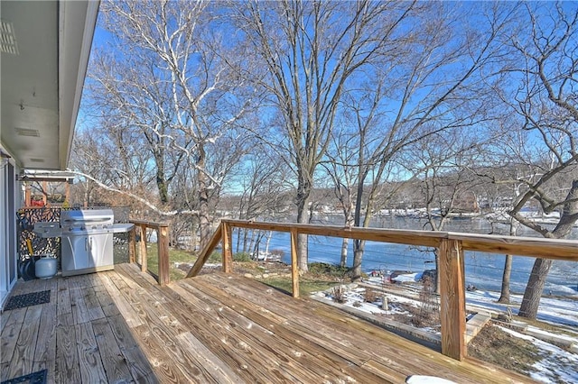 snow covered deck with water heater and area for grilling