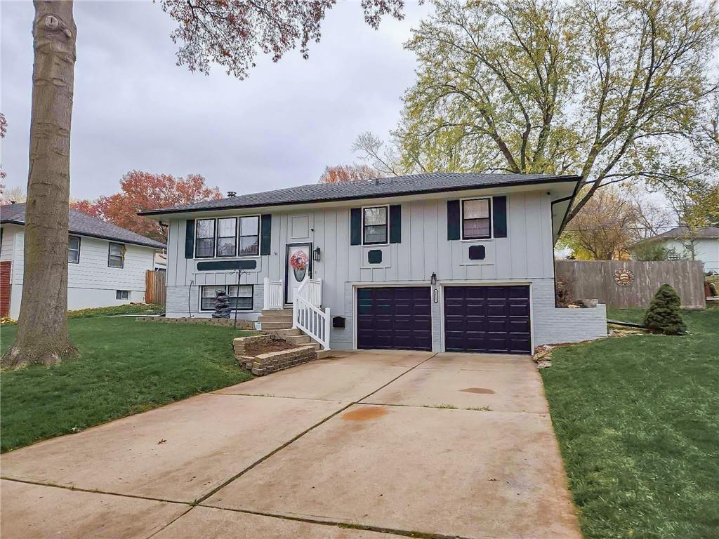 bi-level home with a garage and a front lawn