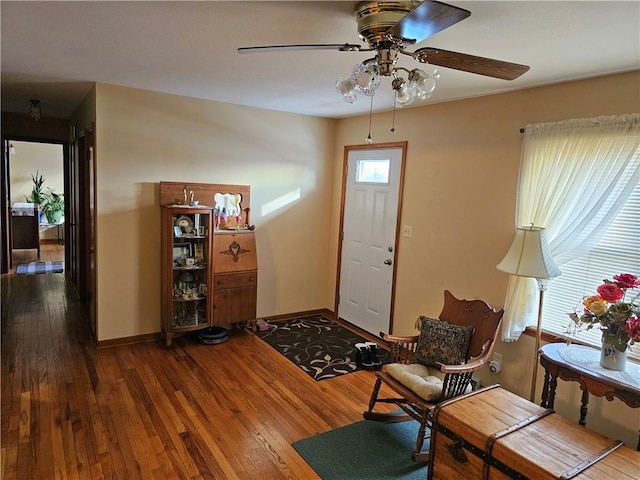 foyer entrance with ceiling fan, baseboards, and hardwood / wood-style flooring