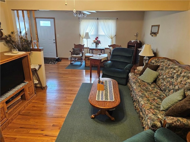 living room with ceiling fan, visible vents, and light wood-style floors