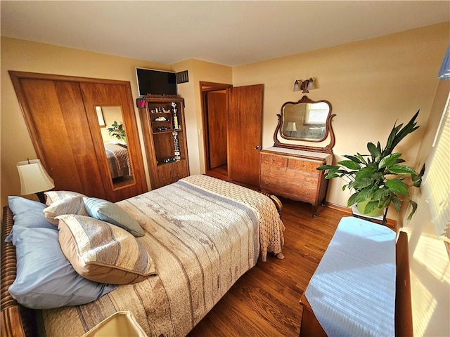 bedroom with dark wood finished floors