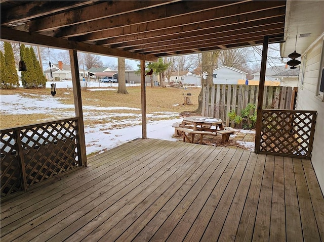 snow covered deck featuring fence