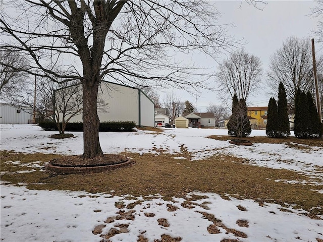 snowy yard with a detached garage