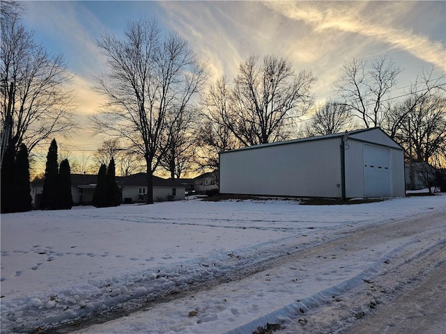 exterior space featuring a detached garage and an outdoor structure