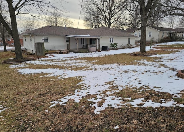 snow covered property with cooling unit