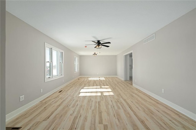 spare room featuring light hardwood / wood-style flooring and ceiling fan