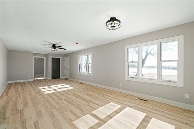 interior space with ceiling fan, plenty of natural light, and light wood-type flooring