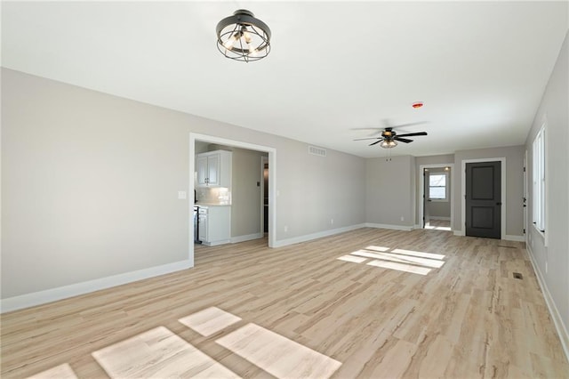 unfurnished living room featuring ceiling fan and light wood-type flooring