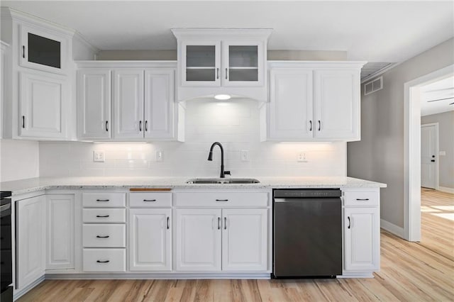 kitchen featuring white cabinetry, sink, dishwasher, and light wood-type flooring