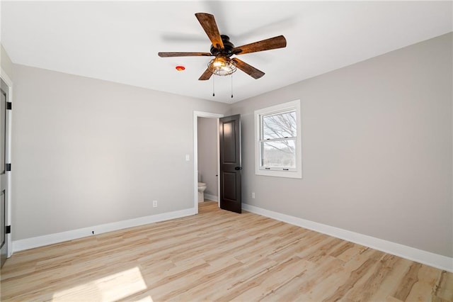 unfurnished bedroom featuring ensuite bath, light hardwood / wood-style floors, and ceiling fan