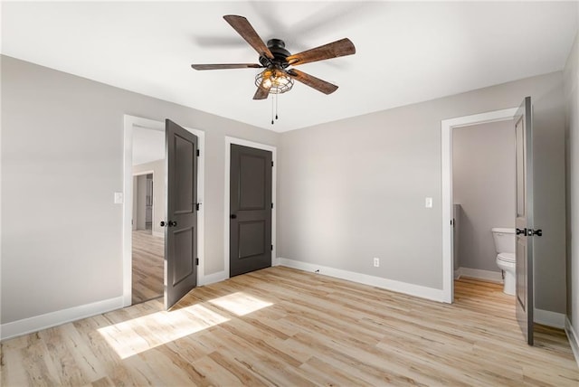 unfurnished bedroom with light hardwood / wood-style floors, ceiling fan, and ensuite bath