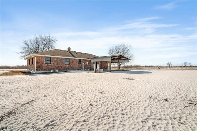 rear view of property with a carport