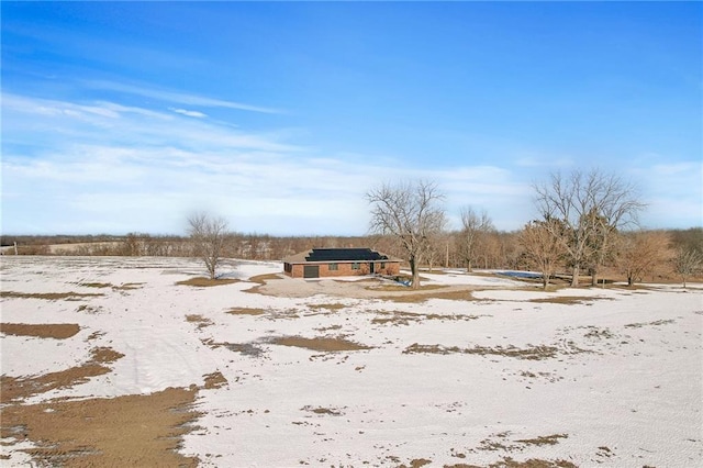 snowy yard with a rural view