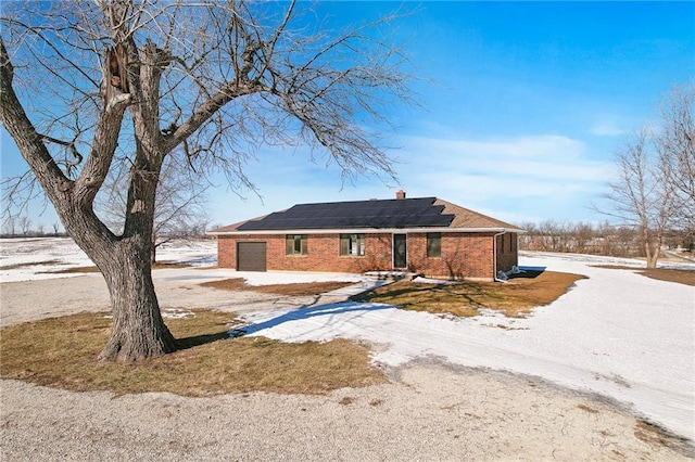 ranch-style house with solar panels