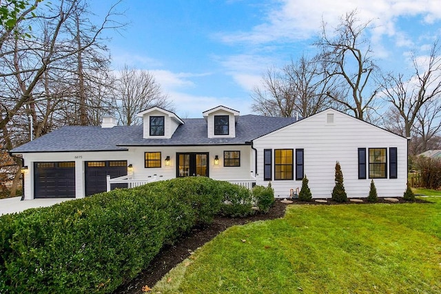 view of front of home featuring a garage and a front lawn