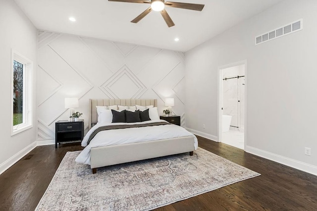 bedroom featuring connected bathroom, dark wood-type flooring, and ceiling fan