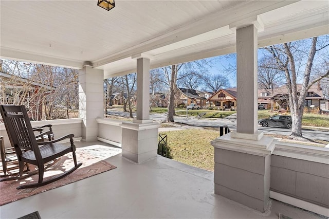 view of patio / terrace with a residential view and covered porch