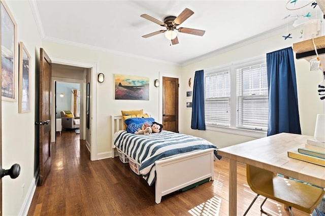 bedroom featuring dark wood finished floors, crown molding, a ceiling fan, and baseboards