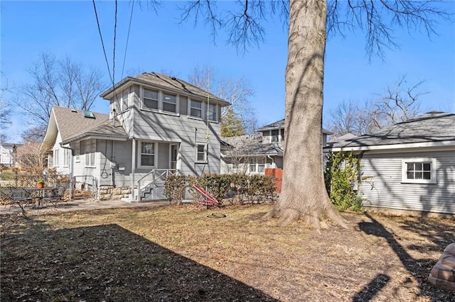 rear view of property with fence