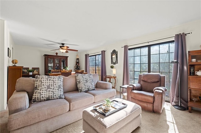 living room with ceiling fan and light colored carpet