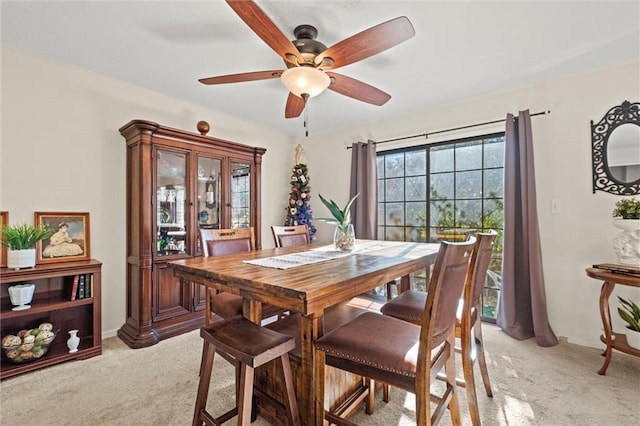 carpeted dining space featuring ceiling fan