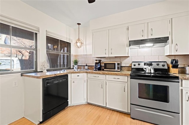 kitchen featuring pendant lighting, appliances with stainless steel finishes, sink, and white cabinets