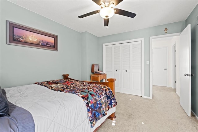 carpeted bedroom featuring a closet and ceiling fan