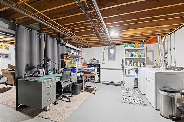 basement with washing machine and clothes dryer and electric panel