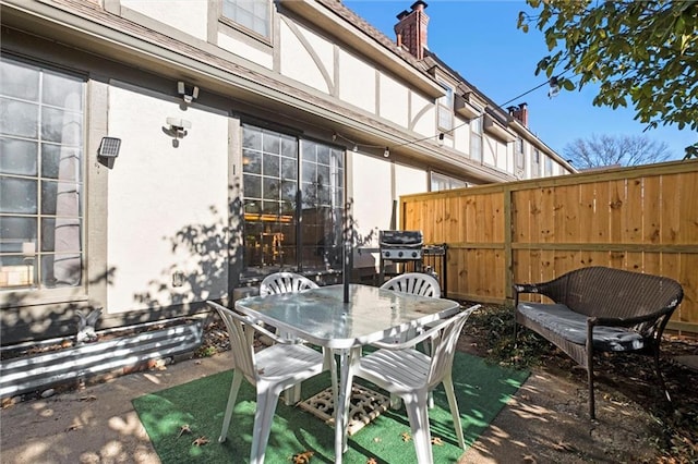 view of patio featuring a grill