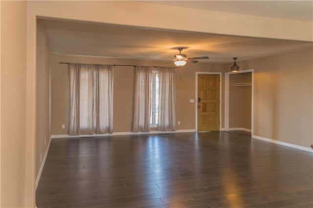 spare room featuring ceiling fan and dark hardwood / wood-style flooring