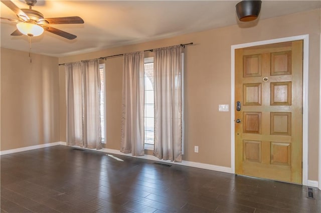 foyer entrance with plenty of natural light, dark hardwood / wood-style floors, and ceiling fan