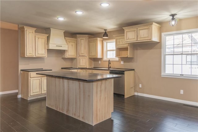 kitchen with dark wood-type flooring, stainless steel dishwasher, custom range hood, and a kitchen island