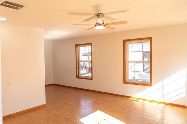 spare room with ceiling fan and light hardwood / wood-style floors