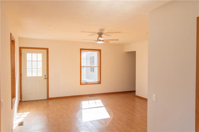 spare room with light hardwood / wood-style flooring and ceiling fan