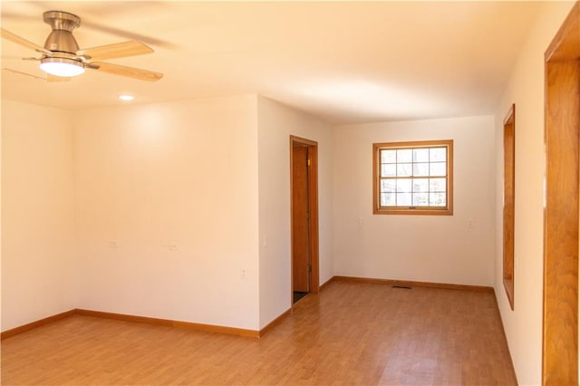 empty room with hardwood / wood-style flooring and ceiling fan