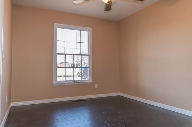 spare room featuring ceiling fan and dark hardwood / wood-style floors